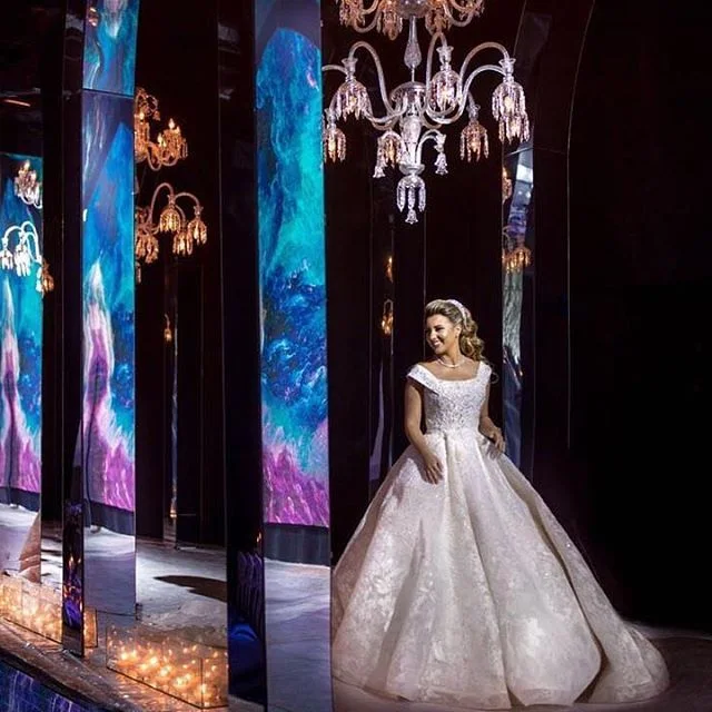 Bride surrounded by illuminated mirrored panels