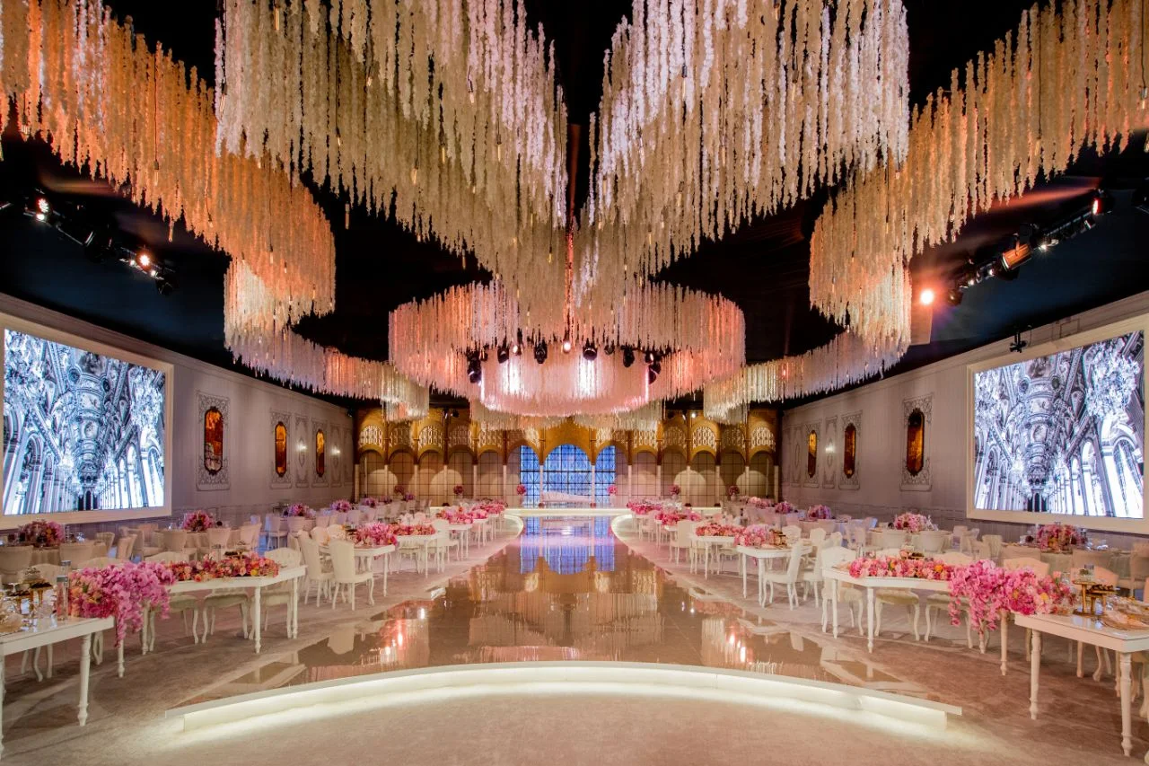 Grand wedding ballroom with reflective flooring and ceiling lights