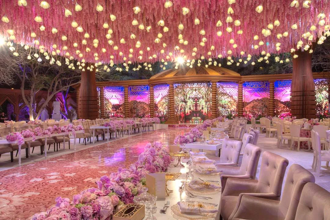 Bride walking through an immersive white floral installation